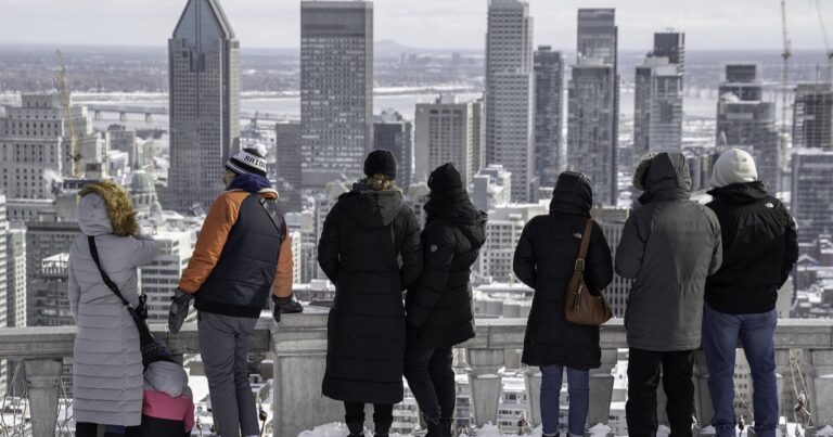 People looking out over the skyline of a Canadian city