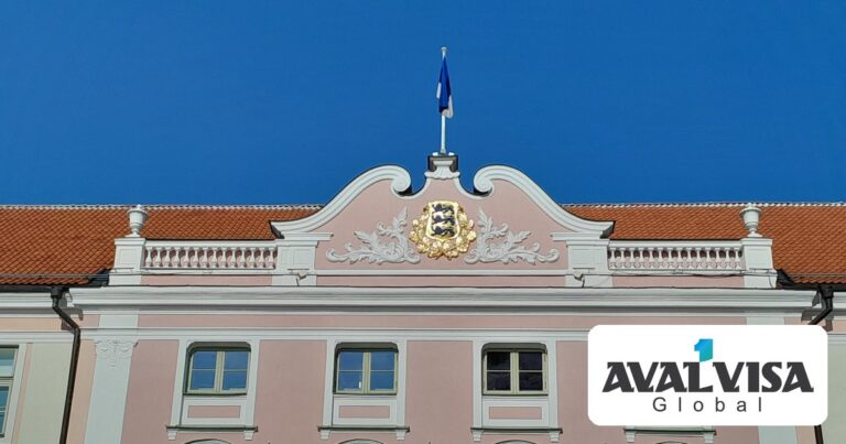 The Estonian coat of arms and national flag on the facade of the Riigikogu at Toompea Castle in Tallinn